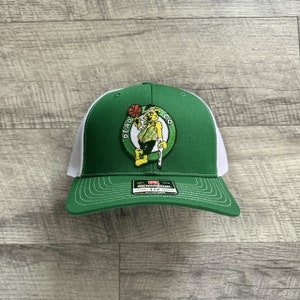 May include: Green and white trucker hat with an embroidered logo of a cartoon leprechaun holding a basketball and the text "Dead Co."