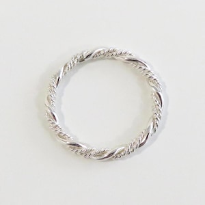 May include: A silver ring with a twisted rope design.