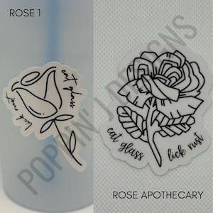 May include: Two black and white rose illustrations with text. The first rose is a simple line drawing with the text "Lick your lips eat glass". The second rose is more detailed with the text "eat glass lick rust". The text "ROSE 1" appears at the top of the image and "ROSE APOTHECARY" appears at the bottom.