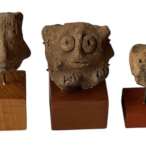 Three Pre-Columbian Museum Quality Artifact Clay Head Fragments. Mounted on square wooden stands.