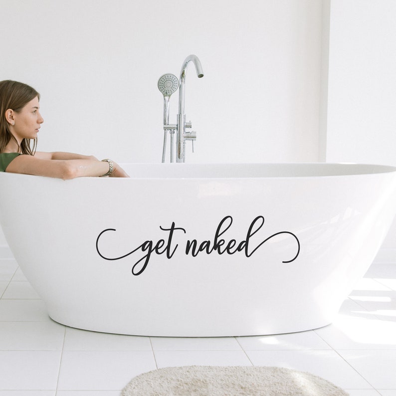 May include: A white bathtub with the text "get naked" written in black cursive script on the side.