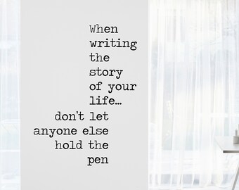 May include: A white wall with black text that reads "When writing the story of your life... don't let anyone else hold the pen."