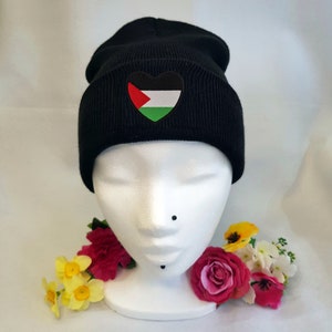 May include: Black beanie with a heart-shaped Palestinian flag patch.