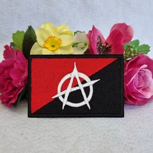 May include: Black and red embroidered patch with a white anarchy symbol.