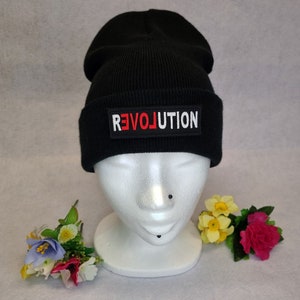 May include: Black beanie with a red and white "REVOLUTION" patch.