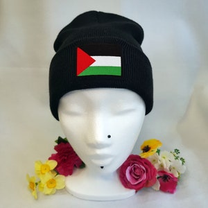 May include: Black beanie with a Palestinian flag patch on the front.