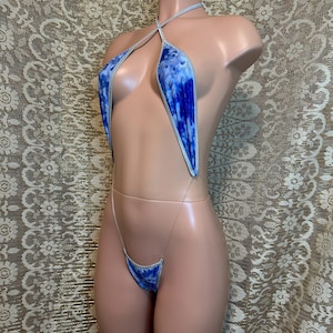 May include: A blue and white tie-dye swimsuit with a halter top and a string bottom. The swimsuit is on a mannequin.