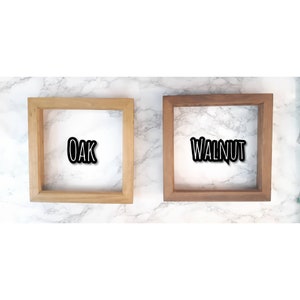 May include: Two wooden picture frames, one in oak and one in walnut. The frames are both empty and have a simple design.