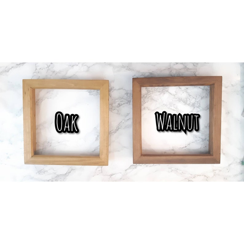 May include: Two wooden picture frames, one in oak and one in walnut. The frames are both empty and have a simple design.