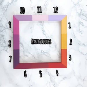 May include: A wooden frame with 12 different colored squares, numbered 1 through 12. The frame is on a white marble surface. The text "MATT COLOURS" is in the center of the frame.
