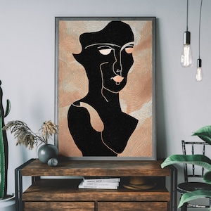 May include: Abstract line art print of a person's face with a black and white color scheme. The background is a light brown color with a textured pattern.