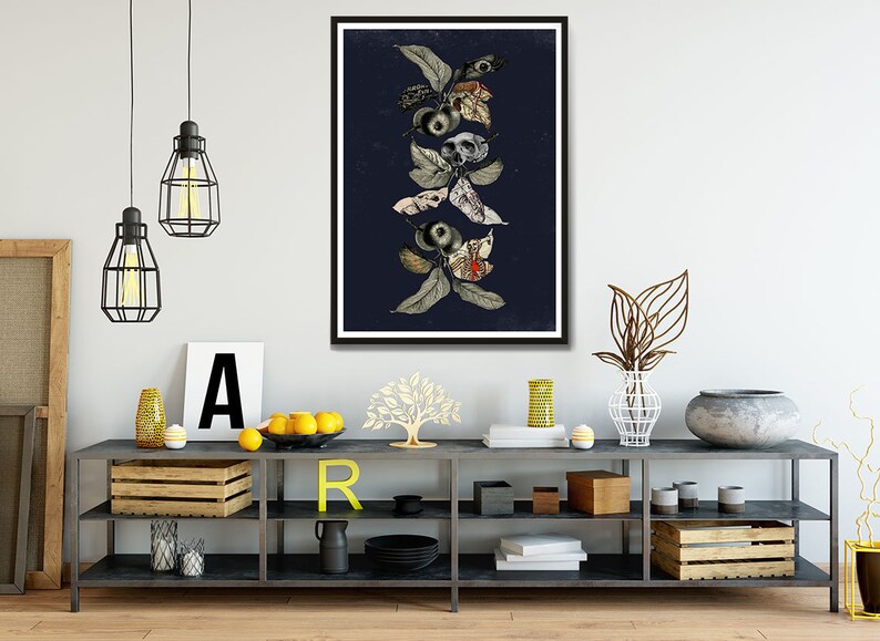 May include: A framed print of a botanical illustration featuring a dark blue background with a vertical arrangement of stylized leaves, flowers, and skulls in shades of gray, white, and red.