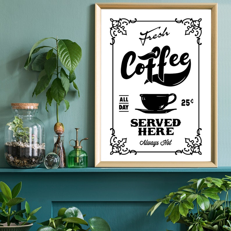 May include: A black and white vintage style sign with the text "Fresh Coffee Served Here Always Hot" and a coffee cup illustration. The sign is framed in gold and hanging on a teal wall.