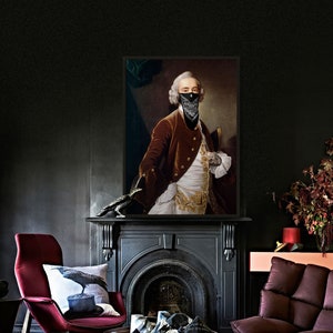 May include: A framed portrait of a man wearing a black bandana over his mouth and nose. He is wearing a red velvet jacket with gold trim and a white shirt. The portrait is set against a dark background.