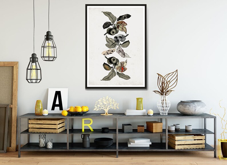 May include: A framed print of a stylized illustration of a branch with leaves and apples. The apples are replaced with skulls and eyes. The background is white.