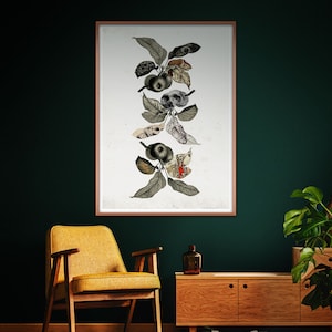 May include: A framed print of a botanical illustration featuring a stylized apple tree with anatomical details, including a skull, an eye, and a skeleton. The artwork is on a white background with a brown frame.