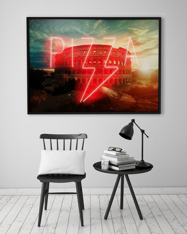 May include: A framed print of the Colosseum in Rome with a neon sign that says "PIZZA" in front of it. The sign is red and has a lightning bolt design.