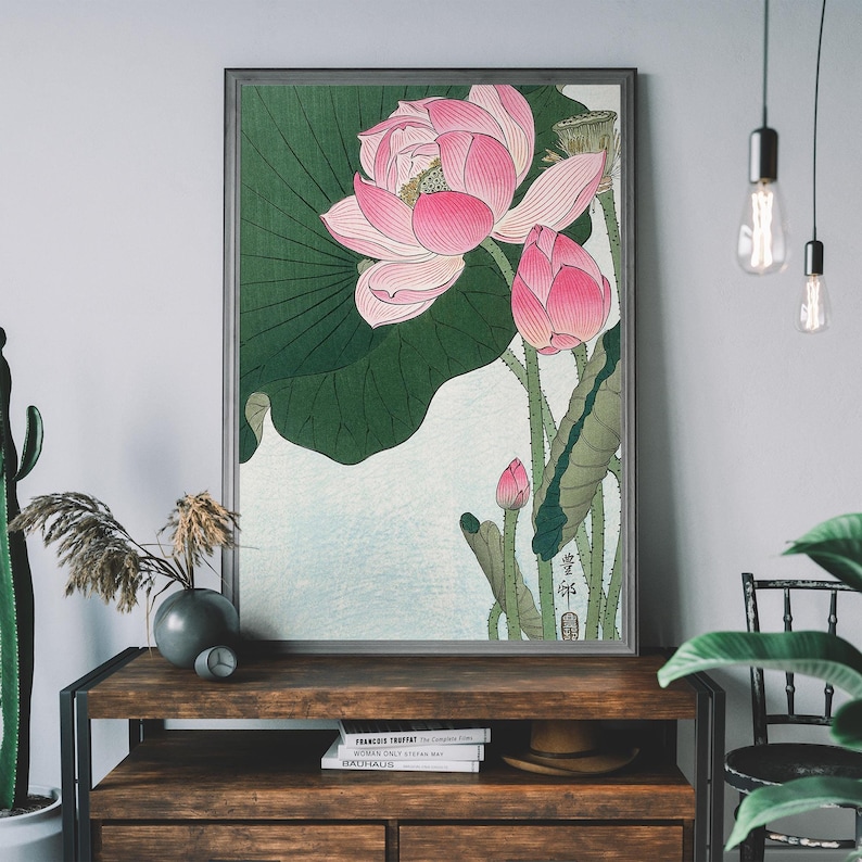 May include: A vintage Japanese woodblock print featuring a pink lotus flower with green leaves. The print is framed in a dark wood frame.