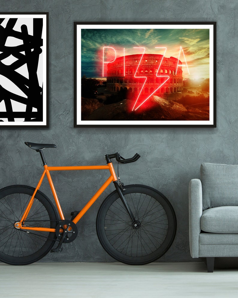 May include: A framed print with a photo of the Colosseum in Rome, Italy. The word "PIZZA" is written in neon pink letters with a lightning bolt symbol in the center. The sky is a vibrant orange and yellow.