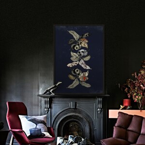 May include: A black and white illustration of a branch with leaves and apples. The apples are decorated with skulls and other details. The illustration is framed and hanging on a dark wall.