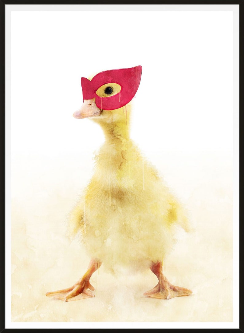 May include: A yellow duckling wearing a red superhero mask. The duckling is standing on a white background.