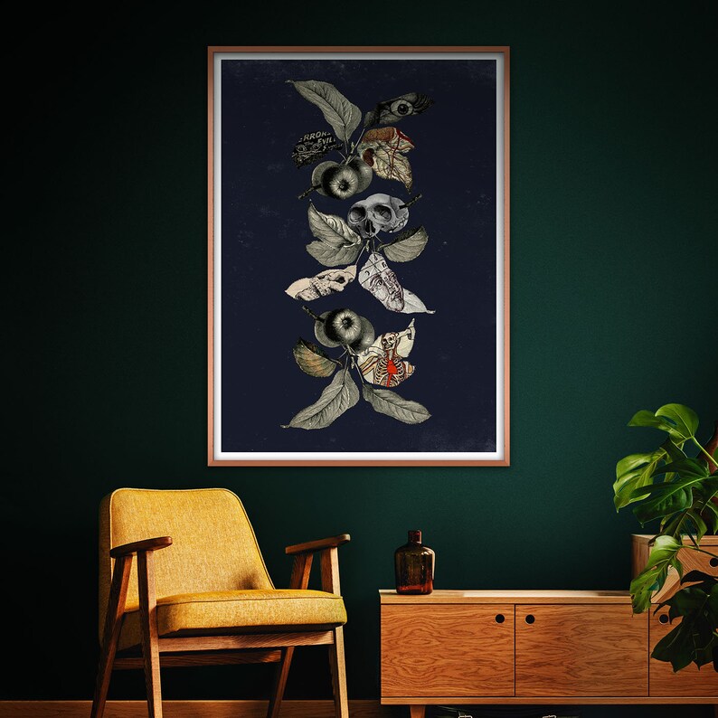 May include: A dark blue framed print with a collage of a skeletal hand, a skull, and a human heart, all intertwined with leaves and apples.
