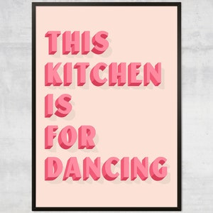 May include: Pink and white printable wall art with the text "This Kitchen is for Dancing" in a 3D style font.