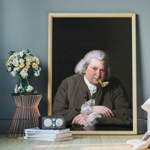 May include: A framed portrait of a man in a brown coat with a white collar and a white wig. He is holding a colorful party blower in his mouth. The portrait is set against a dark background.