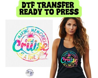 May include: A black tank top with a rainbow tie-dye design featuring the text "Making Memories One Cruise At A Time".