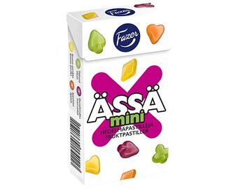 May include: A box of Fazer ÅSSA mini fruit sweets. The box is white with a pink and purple X design. The sweets are in the shape of hearts, diamonds, and clover leaves. The text on the box reads "ÅSSA mini Hedelmäpastilleja Fruktpastiller".
