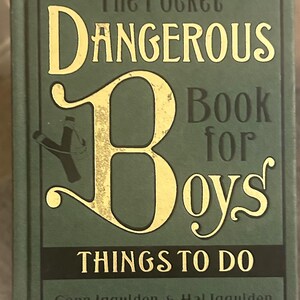 May include: A green hardback book, "The Pocket Dangerous Book for Boys: Things to Do", with gold lettering and a slingshot illustration. The authors are Gonn Iggulden & Hal Iggulden. A classic guide for young readers.