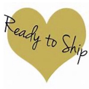 May include: A gold heart-shaped graphic with the text "Ready to Ship" in black cursive writing.