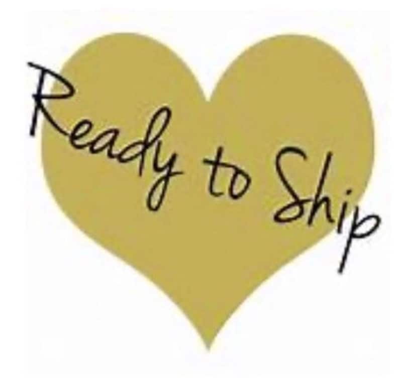 May include: A gold heart-shaped graphic with the text "Ready to Ship" in black cursive writing.