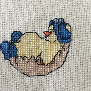 Cross-stitched baby girl chick