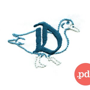 May include: Embroidered duck design with the letter "D" in teal blue. The duck is outlined in teal blue thread, with a white body and light blue feet. The design is on a white background. A red circle with the text ".pdf" is in the bottom right corner.