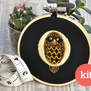 May include: Embroidery kit featuring a gold owl design on black fabric in a 6-inch embroidery hoop. The kit includes all the materials needed to complete the project.