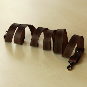 This wide strap is made of high quality genuine Crazy Horse leather. It is durable and reliable, and has a matte fine grain finish that takes on a vintage look over time.