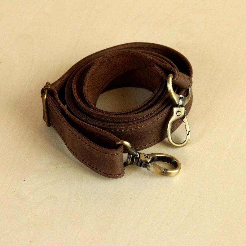 Genuine Leather Shoulder Strap with Swivel Hooks, Removable Crossbody Strap, Rotating Clasp Strap, Detachable Adjustable Leather Crossbody Strap: Antique Brass Swivel Hooks, 1" wide
 
 This wide strap is made of high quality genuine Crazy Horse leather. It is durable and reliable, and has a matte fine grain finish that takes on a vintage look over time.
All metal hardware are sturdy and reliable. Rivets and swivel hooks are available in Antique (Brass).