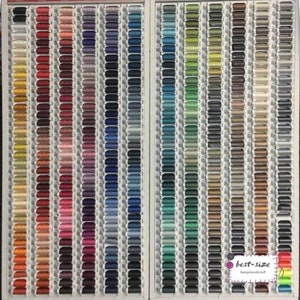 May include: A wall display of hundreds of spools of thread in various colors, organized by color family. The spools are arranged in rows and columns, creating a colorful and visually appealing display. The text "best-size #wirgberndirnstiff" is visible in the lower right corner of the image.