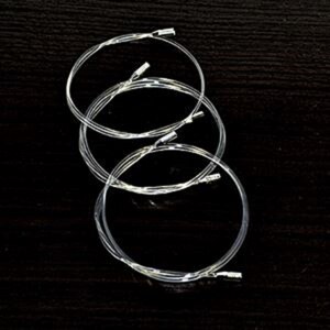 May include: Four silver guitar strings wound together in a coil.