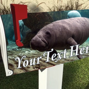 May include: A white mailbox with a red flag, featuring a manatee swimming underwater. The image includes the text "Your Text Here" in a decorative font. The background shows a sandy ocean floor.