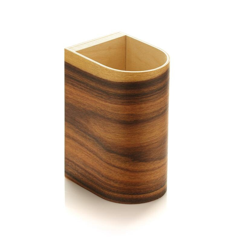 May include: A wooden pencil holder with a brown wood grain pattern. The holder is cylindrical and has a rounded top.