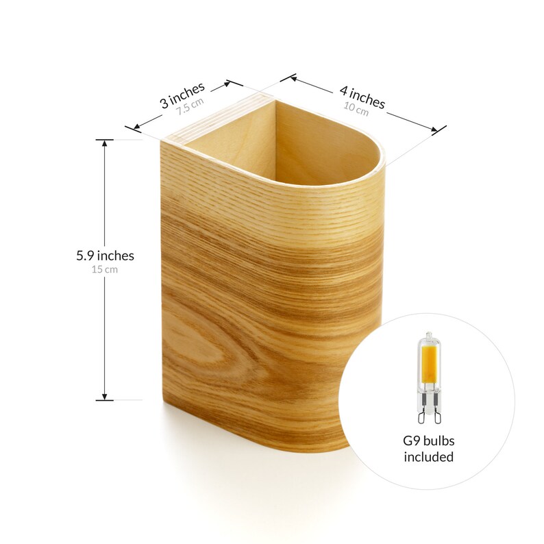 May include: A wooden wall sconce with a curved design. The sconce is 5.9 inches tall, 3 inches wide, and 4 inches deep. It includes two G9 bulbs.
