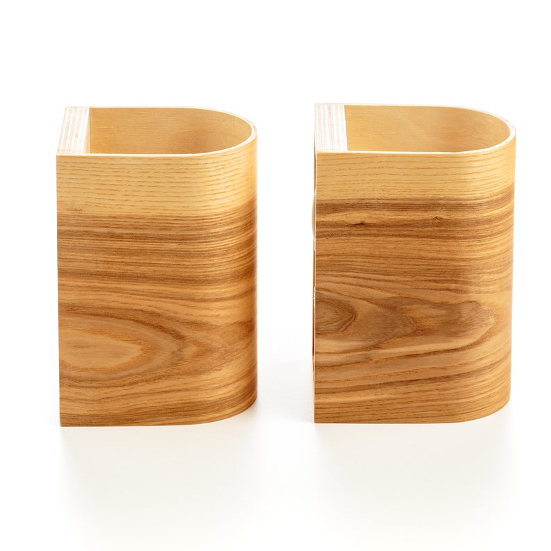 May include: Two wooden storage containers with a curved front and a natural wood grain finish.