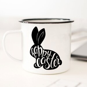 May include: White enamel mug with a black silhouette of a bunny rabbit with the text "happy easter" inside the silhouette.
