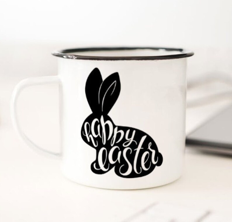 May include: White enamel mug with a black silhouette of a bunny rabbit with the text "happy easter" inside the silhouette.