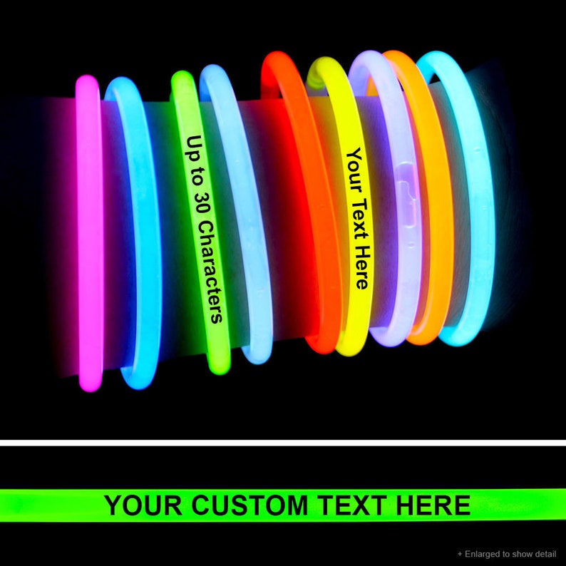 May include: Assortment of glow sticks in various colors, including pink, blue, green, yellow, orange, and purple. The glow sticks are arranged in a circle and are lit up. The text "Your Text Here" and "Up to 30 Characters" is printed on the glow sticks. The text "YOUR CUSTOM TEXT HERE" is printed in green on a black background.