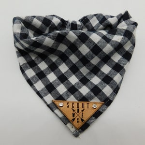 May include: Black and white checked bandana with a triangular wooden patch that says "SCOUT" with arrows pointing in the four directions.