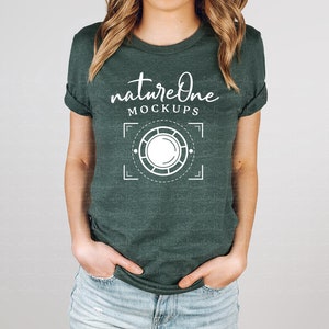 May include: A dark green t-shirt with a white graphic design that says "natureone MOCKUPS" and a stylized circle with a smaller circle inside.
