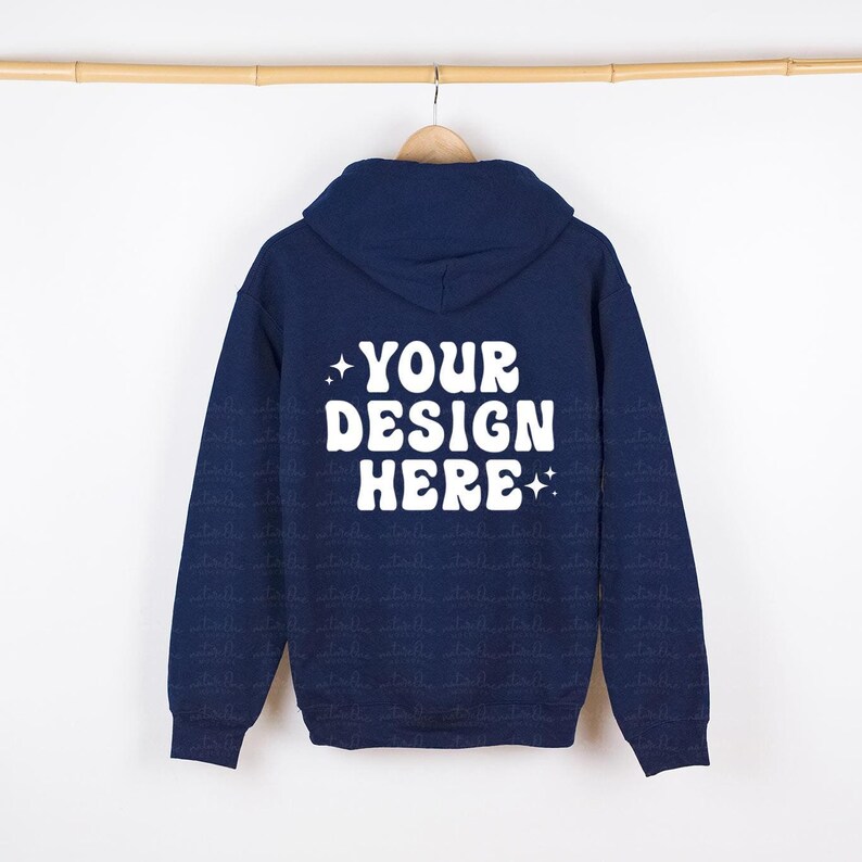 May include: A navy blue hoodie with a white print on the back that says "YOUR DESIGN HERE" with two stars on either side of the text.